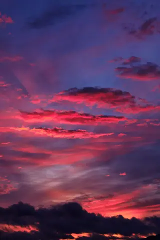 Vibrant red and pink clouds illuminate the Penrith sky at sunset.