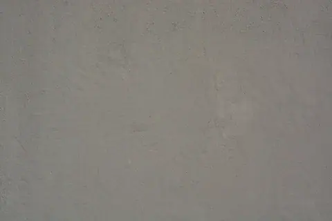 High-resolution image of a gray concrete wall, showcasing rough texture and natural wear.