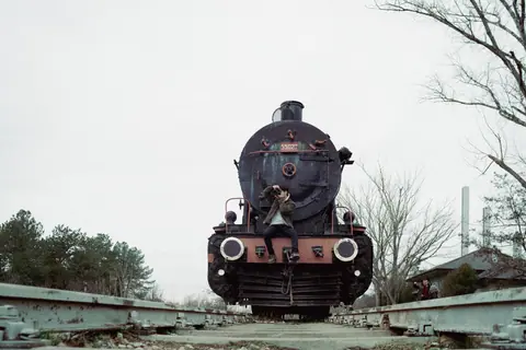 A vintage steam train at Karaağaç Station in Edirne, Türkiye, evoking nostalgia.