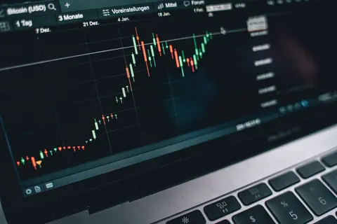 Close-up of a computer screen displaying cryptocurrency market trends and data.