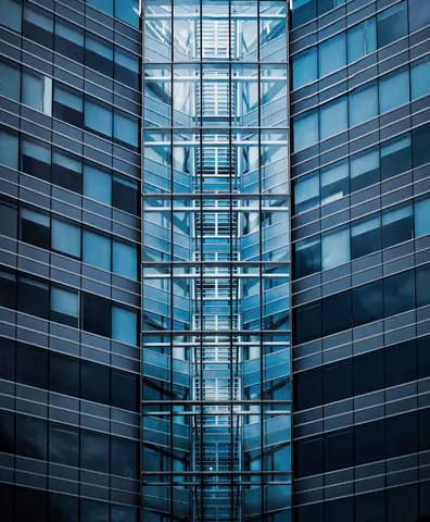 Symmetrical view of a modern glass building showcasing urban architecture.