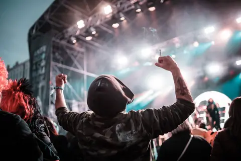 Dynamic crowd at an outdoor concert in A Coruña, Spain, capturing vibrant energy and celebration.