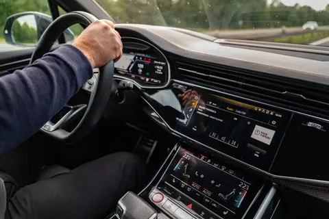 Interior view of a modern car being driven in Osijek, highlighting the dashboard and entertainment system.