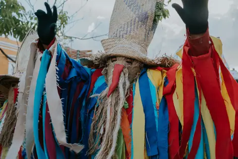 A colorful traditional costume with vibrant ribbons at a festival in Oaxaca, Mexico.