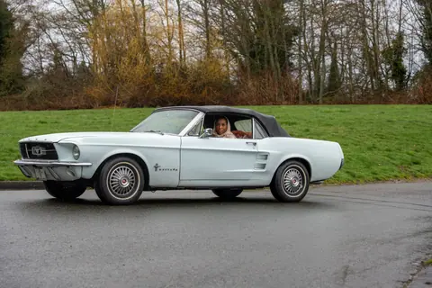 Vintage Ford Mustang with driver on a wet day in Seattle, Washington.