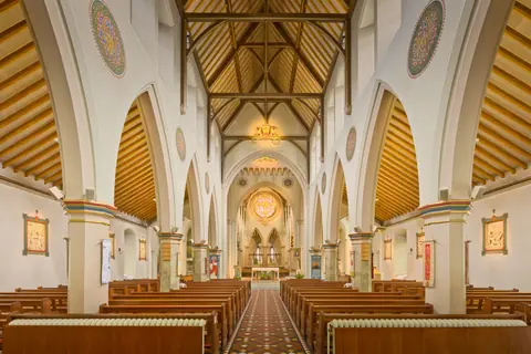 Architectural marvel of a Gothic Revival church interior in England, showcasing intricate arches and historic details.