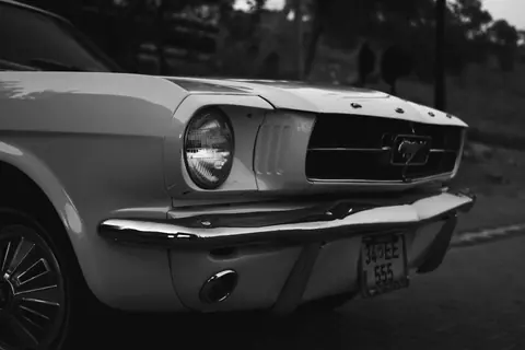A classic Ford Mustang captured in grayscale, showcasing its iconic design.