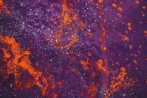 Dynamic abstract art piece featuring vivid purple and orange colors with unique patterns.