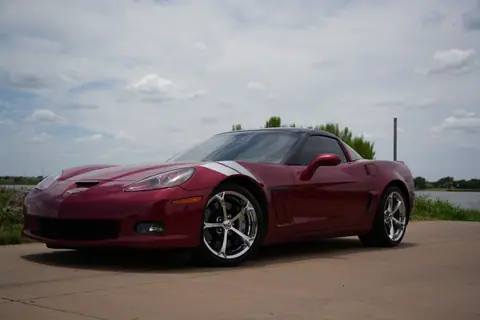Vibrant red sports car parked outdoors under a partly cloudy sky in Wichita Falls.