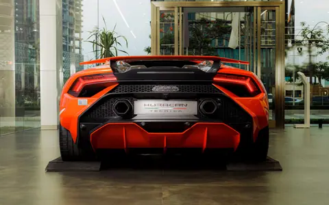 Vibrant red sports car showcased in a modern indoor setting.