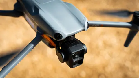 A close-up shot of a drone flying outdoors in Marseille, France, highlighting its camera.