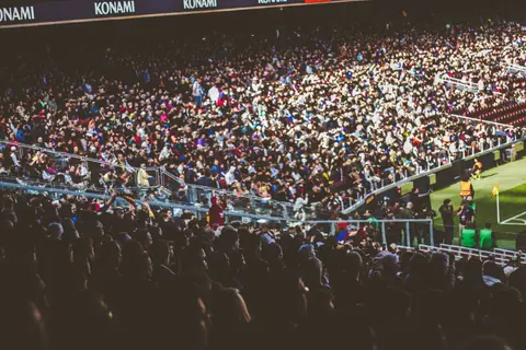 A crowded soccer stadium packed with enthusiastic fans during a match.