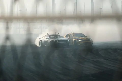 Thrilling car drift racing with smoke effects on a track. Dynamic action scene.