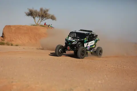 Action-packed off-road rally car racing through the Saudi Arabian desert.