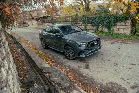 A sleek gray Mercedes-Benz parked on a picturesque autumn street.