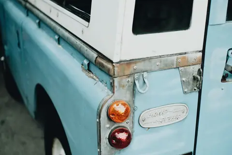 Detailed view of a Land Rover's rear lights showcasing its vintage design.