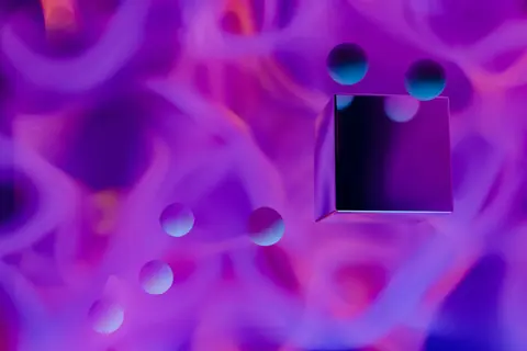 Colorful abstract art with 3D spheres and cube against a vibrant purple background.