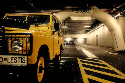 Vintage yellow off-road vehicle parked indoors, highlighting rugged design and nostalgic charm.