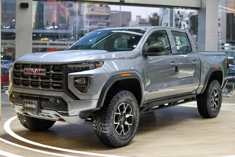 Modern GMC Canyon truck displayed in an upscale showroom in Amman, Jordan.
