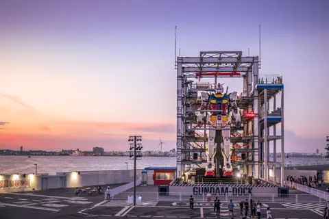A stunning sunset view of the Gundam robot at Yokohama's waterfront, Japan.