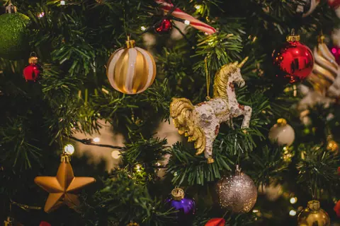Close-up of a beautifully decorated Christmas tree with various ornaments and twinkling lights.