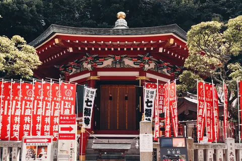 Explore a traditional Japanese shrine with vibrant banners in Tokyo.