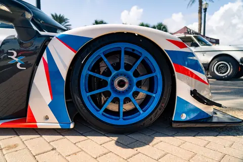 Dynamic image showcasing a sportscar wheel with bold colors and sleek design.