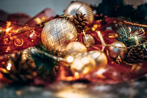 A cozy close-up of sparkling Christmas ornaments and warm golden lights, perfect for festive decor inspiration.