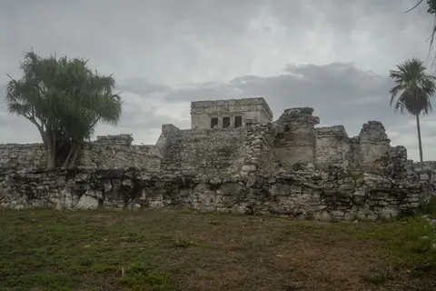 Explore the remarkable ancient Mayan ruins located at Tulum, Mexico against a cloudy sky.