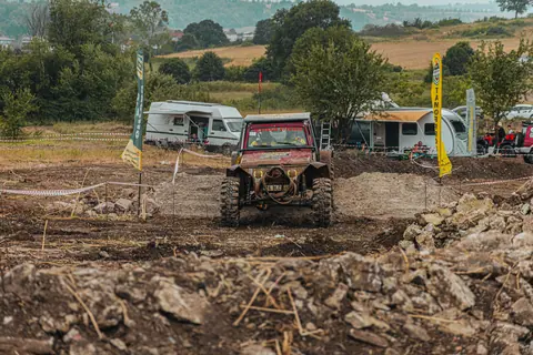 A rugged offroad vehicle navigates a challenging course during an exciting outdoor racing event.