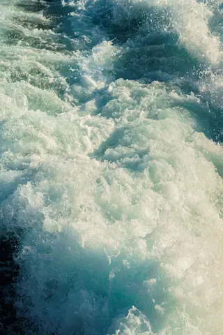 Vivid capture of ocean waves splashing with frothy white water creating a dramatic visual.