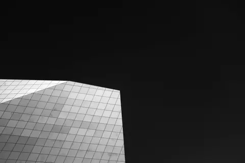A striking minimalist photo of a modern architectural facade against a dark sky.