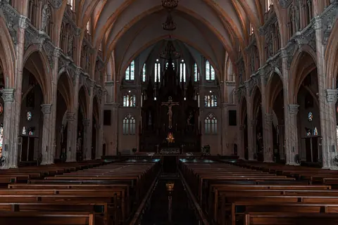 Beautiful view of a Gothic cathedral's interior with detailed arches and altar.