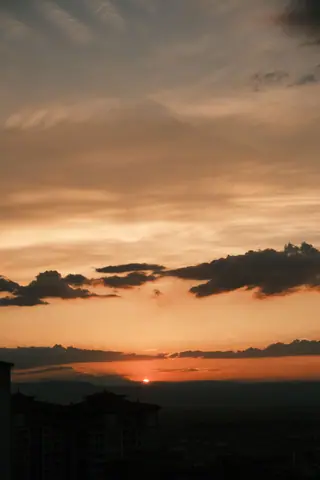 Stunning twilight view of a city skyline under a vibrant sunset sky, capturing the essence of dusk.