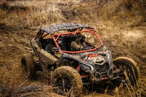Dirt buggy racing through muddy terrain, showcasing offroad adventure and thrill.