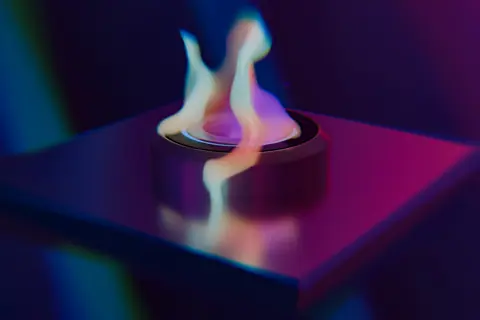 A captivating abstract image showcasing a neon-colored flame against a dark background.