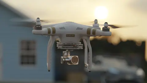 Captivating shot of a drone flying outdoors at sunset, showcasing modern technology.
