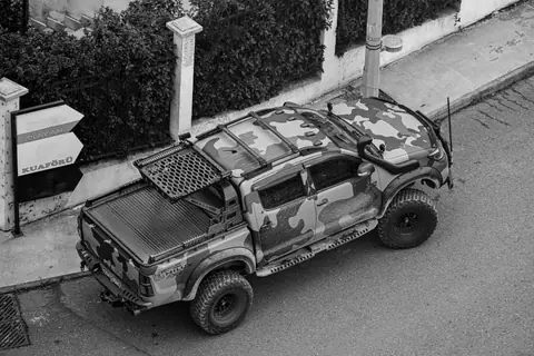 Black and white photo of a camouflaged off-road vehicle on a street in Istanbul, Türkiye.
