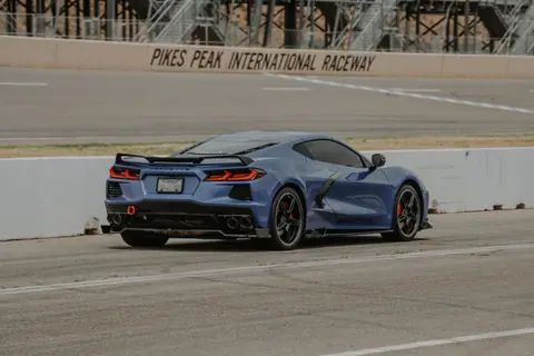Blue Corvette sports car on track at Pikes Peak International Raceway.