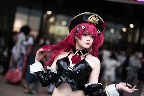 A vibrant cosplay of an anime character with pink hair in a detailed costume outdoors.