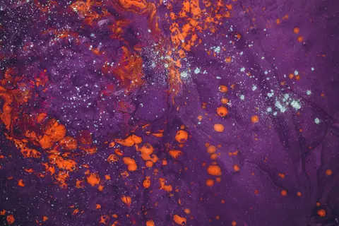 Dynamic abstract artwork showcasing vibrant purple and orange swirls with fluid textures.