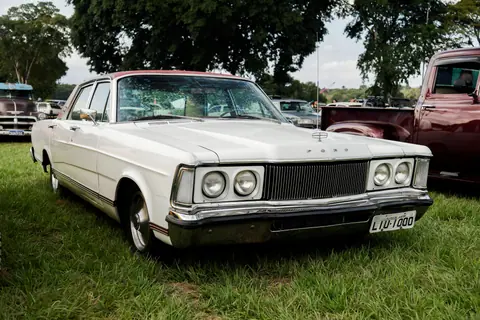 Vintage Ford Galaxie car showcased outdoors surrounded by trees, perfect for automobile enthusiasts.