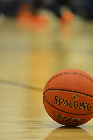 Focused shot of a Spalding basketball resting on an indoor court, ready for the game.