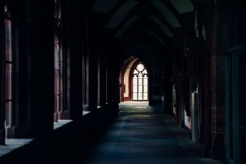 View of a historic gothic church corridor in Basel, showcasing architectural beauty.