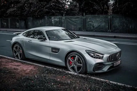 Sleek silver coupe parked on an urban street, showcasing modern design and elegance.