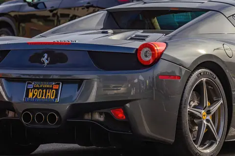 Close-up of a sleek gray Ferrari sports car showcasing its luxury design and iconic brand emblem.