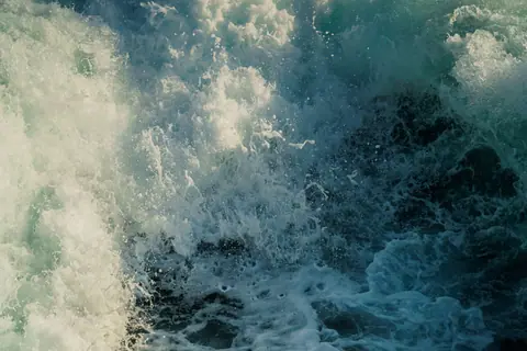 Powerful ocean waves crashing with force, capturing the energy and movement of the sea.