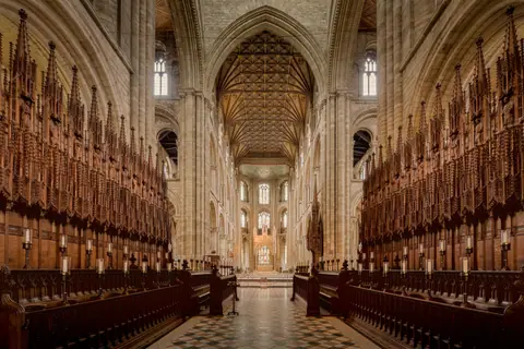 Explore the majestic Gothic architecture of Peterborough Cathedral's interior.