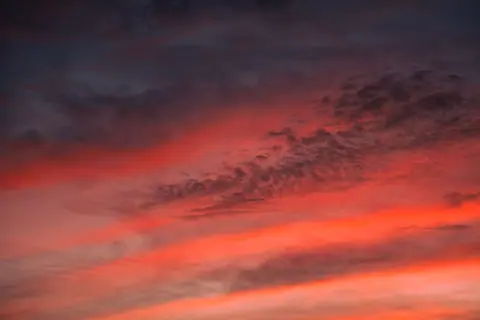 Stunning vibrant sunset sky with dramatic clouds and warm colors.