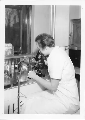 Laboratory Employee Views Samples Through a Microscope, Minneapolis Health Department